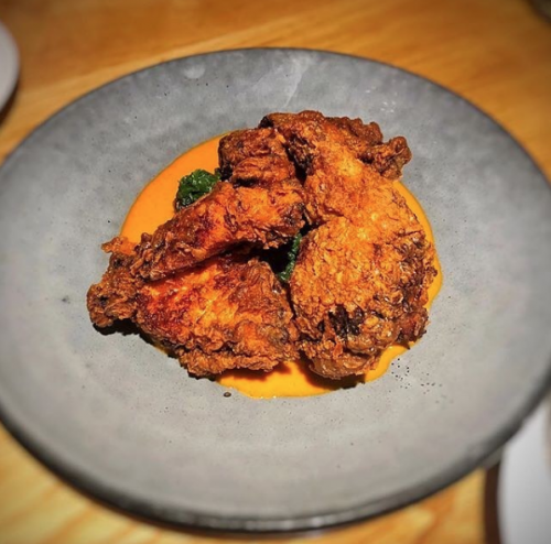 korean fried chicken wings on a gray plate